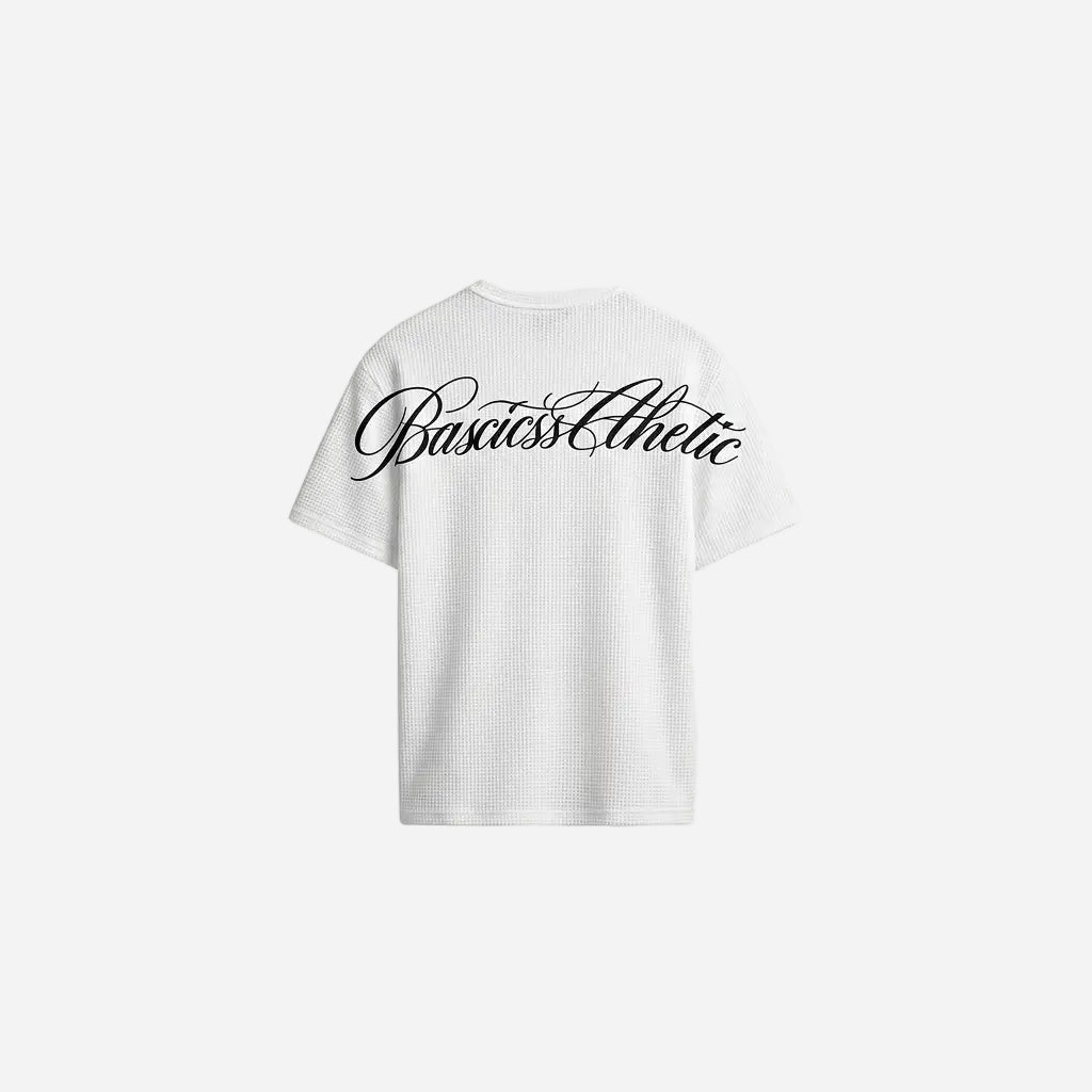 Back view of the BASICSS White Script Waffle T-Shirt, featuring textured fabric, short sleeves and a large black BASICSS Athletic script logo, displayed against a light background.