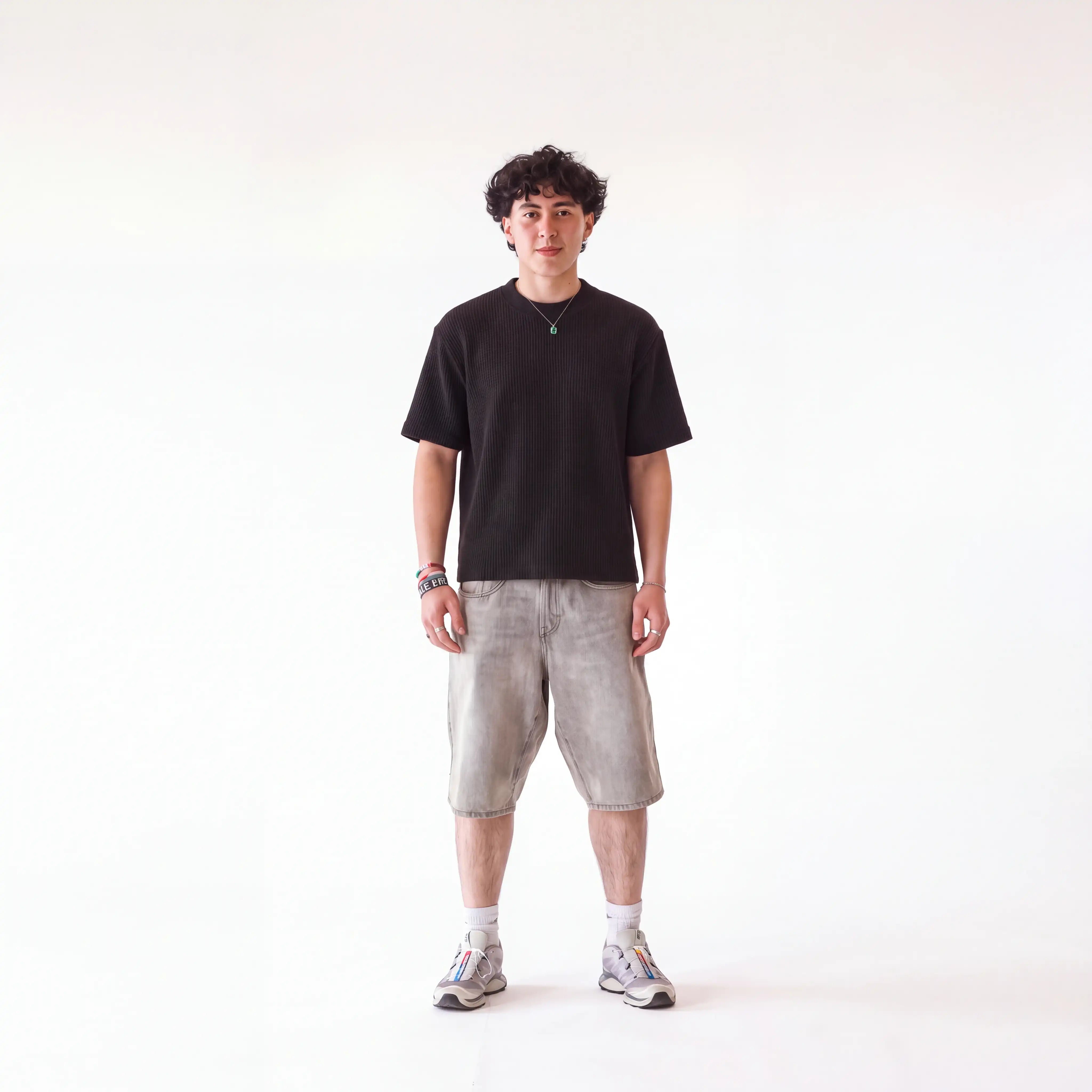 Man wearing black waffle knit tshirt on white background 